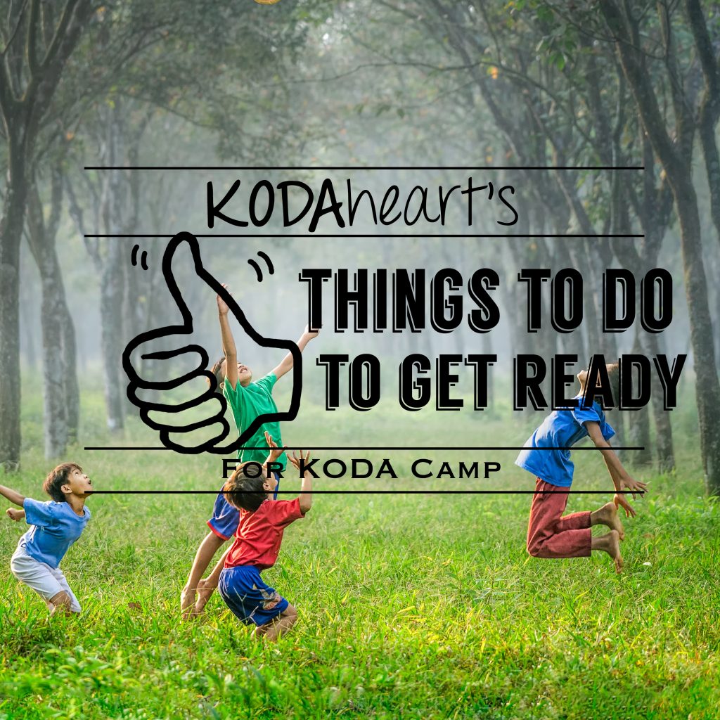 Image description: A thumb outlined in black signs “10” with accompanying text that reads: “KODAheart’s [10] Things to do to get ready for KODA Camp.” In the background is an image of four children mid jump, in a green, wooded area. There is a slight morning fog in the back of the image.