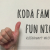 Image Description: a white hand signs "10" against a white background. White text reads "Koda Family Fun Night" and "KODAheart #k3famILY"