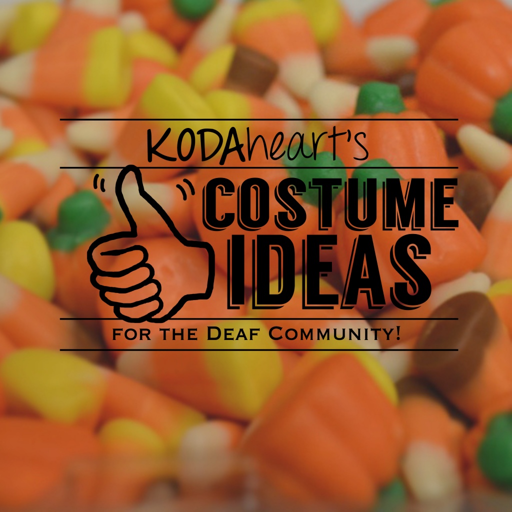Image Description: A thumb, outlined in black, signs “10” with accompanying text that reads: “KODAheart’s [10] Costume Ideas Inspired by the Deaf Community!” In the background, a close-up photograph of candy corn and pumpkins, bright orange, yellow, white, green, and brown candies in the shape of corn and pumpkins.