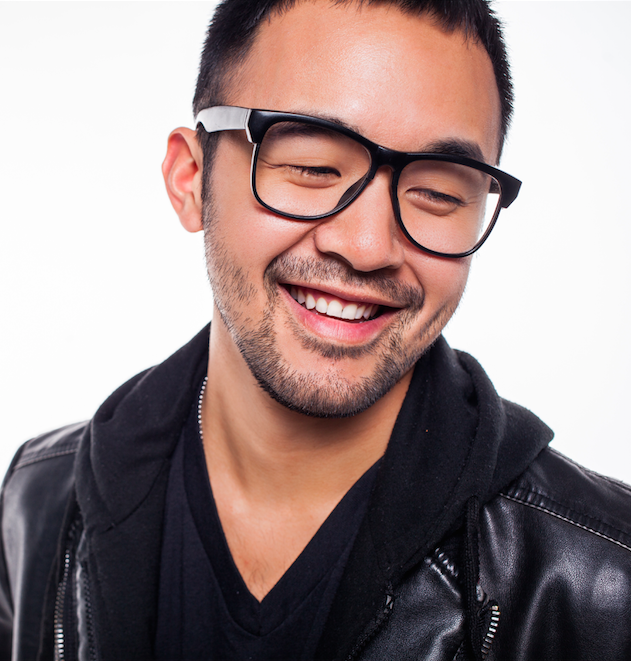 [Image description: a Taiwanese man, smiling, with black rimmed glasses looking to the lower right wearing a leather jacket.]