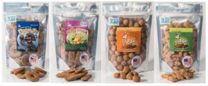 [Image description: Four bags of pet treats in ziplocked bags with see through front covers are lined up side by side Each one with a different name and different shape. The labels from left to right read Dognuts, Kity Roca, Organic pumpkin, and Chehalis Mint. All of the bags have an american flag sticker on the lower right corner with the words “made in america”.]