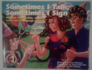 Image Description:”Sometimes I talk, Sometimes I sign” is the title above a woman and man facing a young girl who is wearing a birthday hat. in the background is a bike with balloons attached the the handle bars. The woman and girl have their hands in the air as if they are signing.