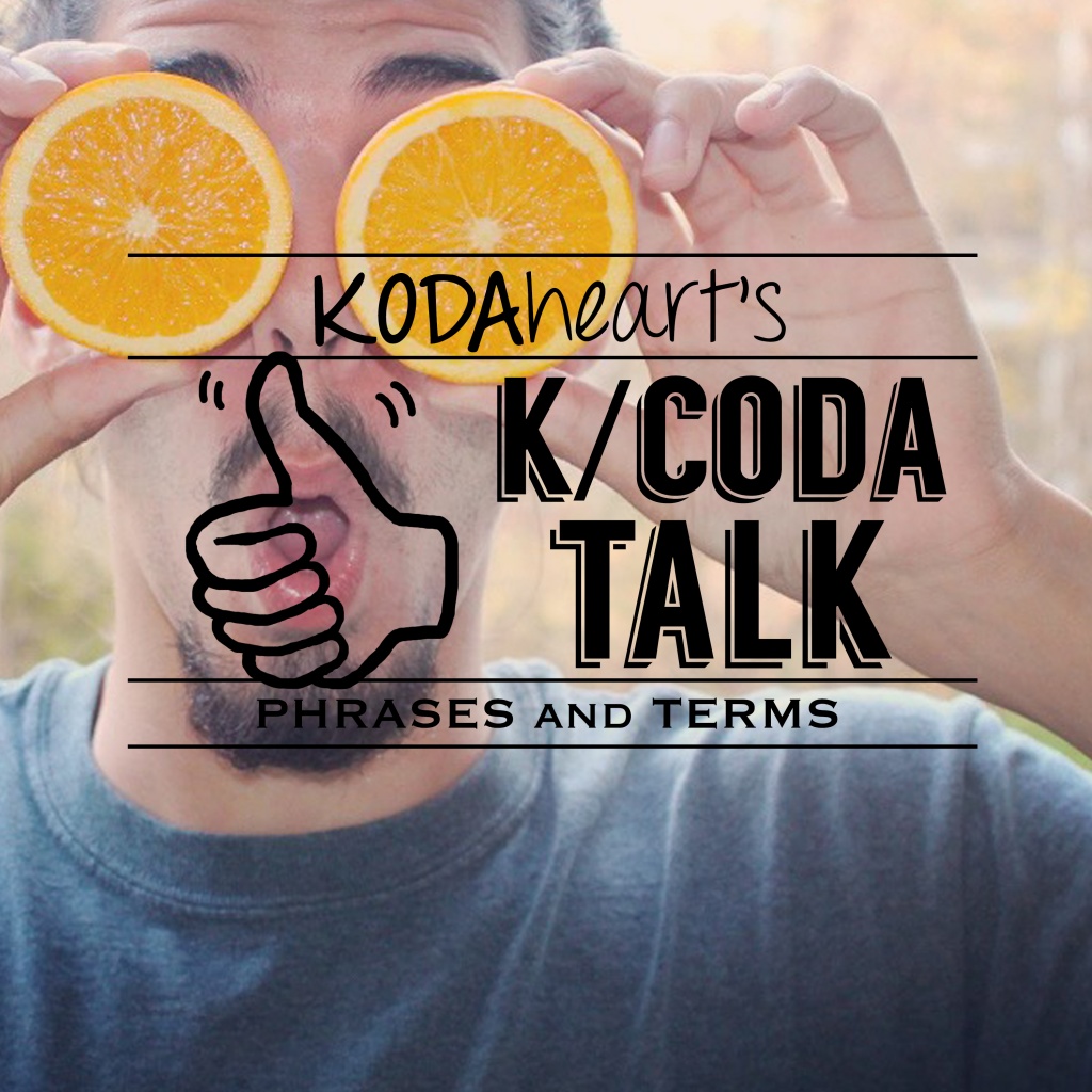 Image Description: In the image a thumb, outlined in black, signs “10” with accompanying text that reads: “KODAheart’s [10] K/Coda talk phrases and terms” . A man wearing a grey t-shirt, holding two halves of an orange in front of his eyes. He has a shocked expression. Behind him trees with fall leaves are visible.