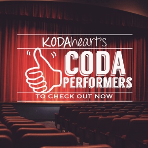 Image Description: A thumb, outlined in black, signs “10” with accompanying text that reads: “KODAheart’s [10] CODA performers to check out now” In the background, rows of seats line the stage of a theatre.