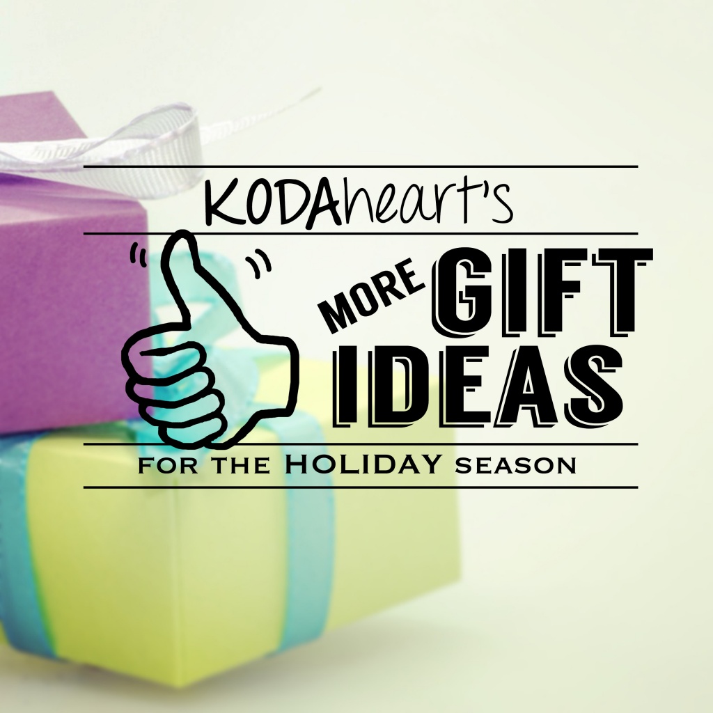 [Image Description: A thumb, outlined in black, signs “10” with accompanying text that reads: “KODAheart’s [10] More Gift Ideas for the Holiday Season.” In the background, a present wrapped in purple paper with a white bow lays on top of a present wrapped in yellow paper with a blue blow.] 