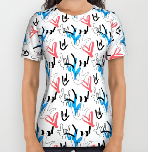 [Image description: White t-shirt with ILY signs drawn four different ways, three in black, one in blue cover the shirt in horizontal columns along with several doodled pink hearts.]