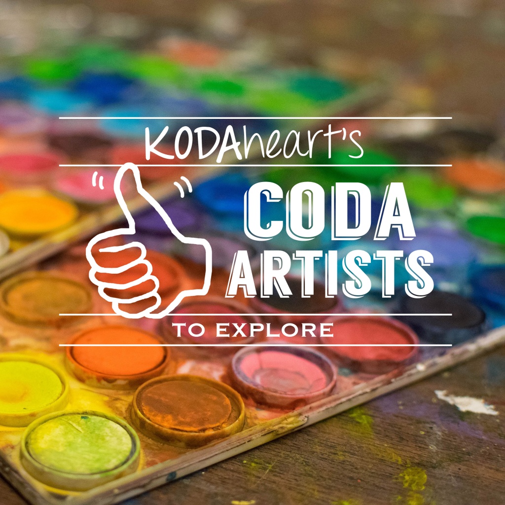 Image description: A photograph of two water-color palettes, smudged with vibrant colors, laying on a wooden table. Smudged dabs of color are visible on the table. Layered on top in white, is a thumb, signing “10” with accompanying text that reads: “KODAheart’s [10] Coda Artists to Explore.”