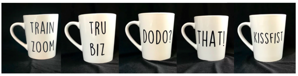 [Image description: Five white mugs are pictured with various ASL sayings in black text. They read “Train zoom”, “Tru biz”, “DoDo?”, “That!”, and “Kissfist”.