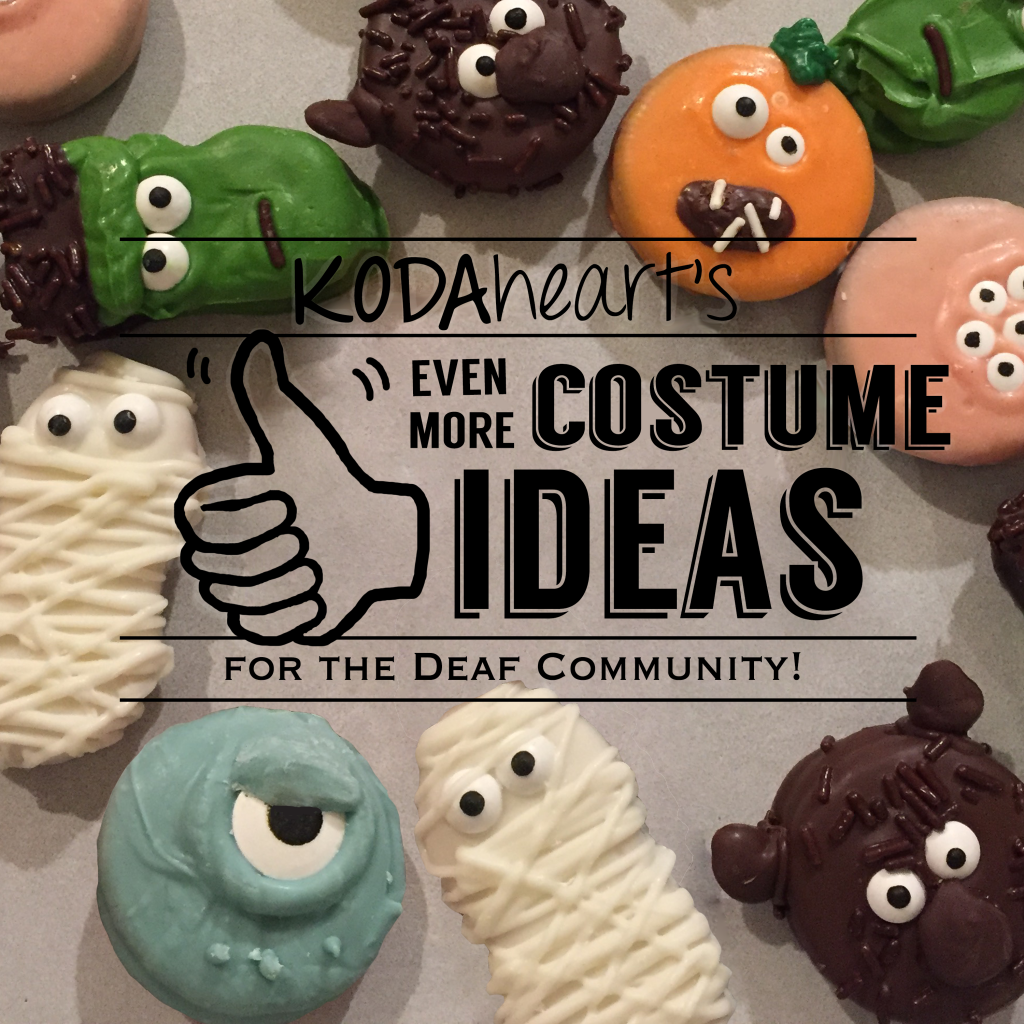 Image Description: A thumb, outlined in black, signs “10” with accompanying text that reads: “KODAheart’s [10] Even More Costume Ideas Inspired by the Deaf Community!” In the background, a close-up photograph of various halloween decorated cookies including Frankenstein, werewolf, jack-o-lantern, and other various monsters.