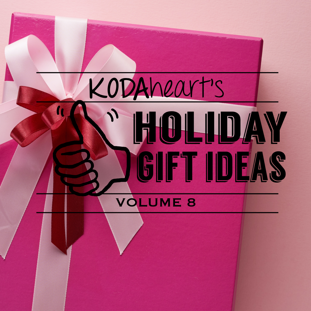 Image description: A thumb outlined in black signs "10" with accompanying text that reads: "KODAheart's [10] Holiday Gift Ideas Volume 8". The background image is a gift wrapped in dark pink paper topped with a light pink bow and ribbon towards the left upper corner. In the middle of the light pink bow is a smaller red bow.